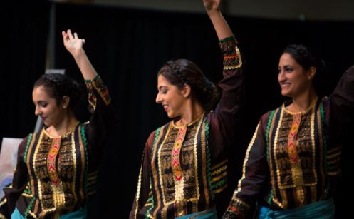 Three women dancing and smiling