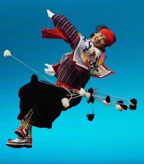 Person floating in the air, wearing decorative clothing.